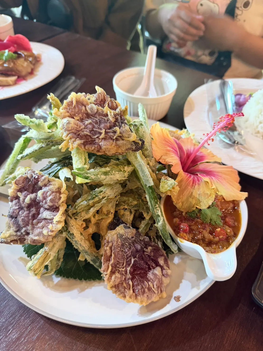Garden greens and edible flowers, fried and served with nam phrik